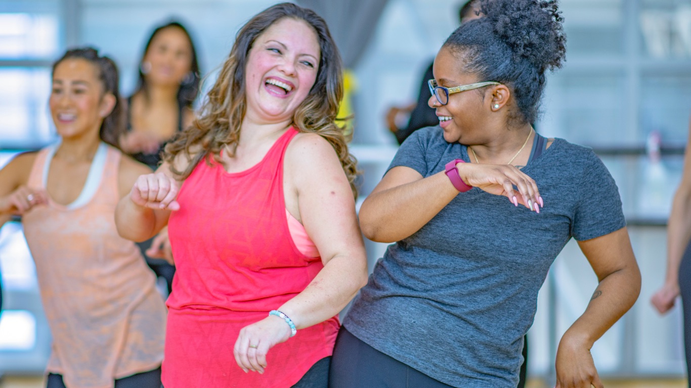 A coach guiding a woman through arm positioning