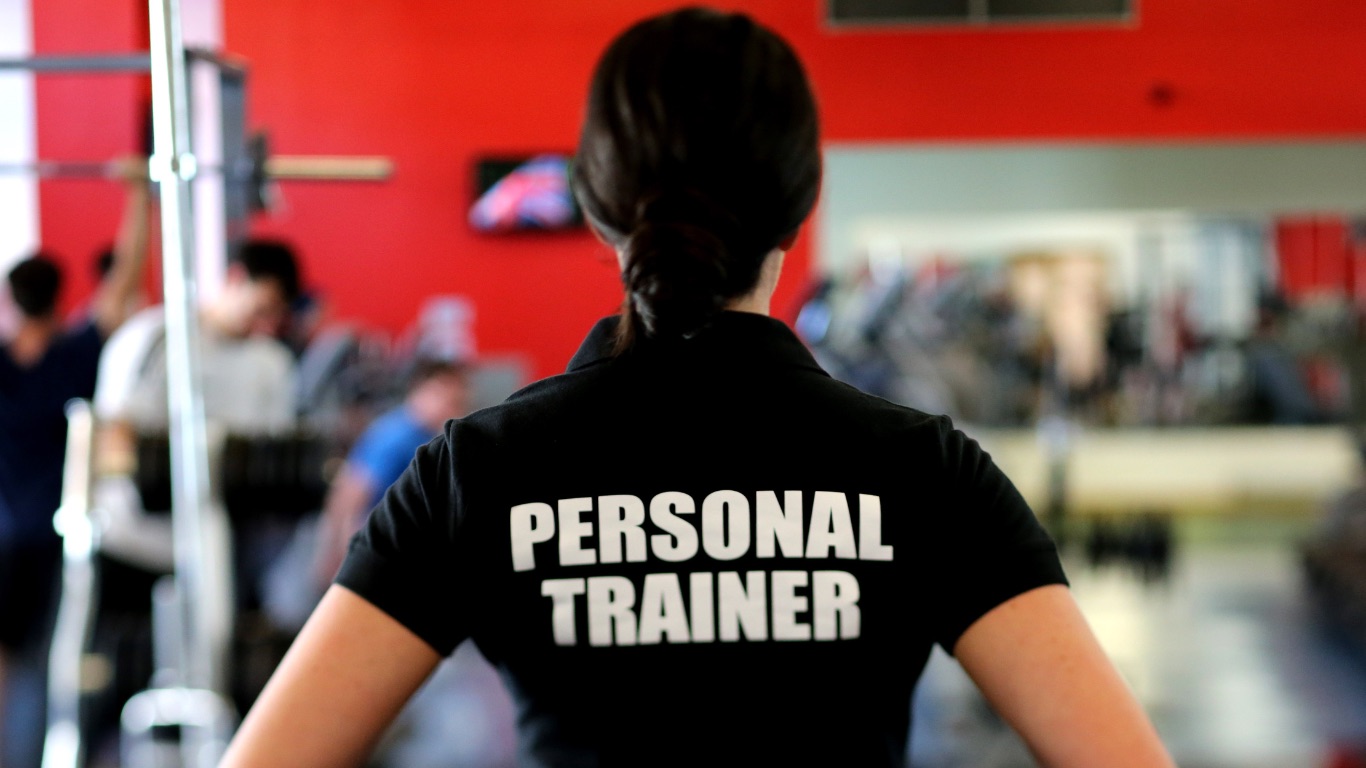 Personal trainer coaching in a gym environment